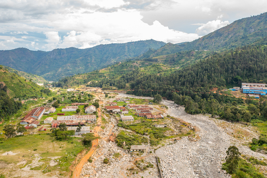 Aerial view of the Kilembe mining area with industrial buildings a rocky riverbed and surrounding mountains in Kilembe Western Region Uganda. Aerial view of the Kilembe mining area with industrial buildings a rocky riverbed and surrounding mountains in Kilembe Western Region Uganda.