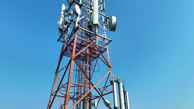 Aerial view of a technician working on a telecom tower Bangladesh.