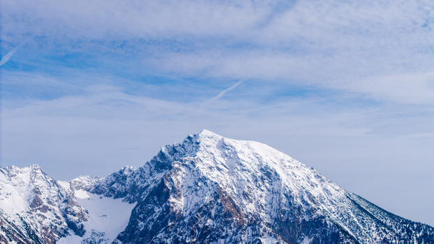 Aerial view of snow capped peaks piercing the expansive blue sky their white crests contrasting against the distant blue Windischgarsten Upper Austria Austria. Aerial view of snow capped peaks piercing the expansive blue sky their white crests contrasting against the distant blue Windischgarsten Upper Austria Austria.