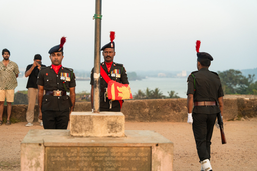 Sri Lanka 24 January 2026 View of soldiers in ceremonial uniforms with red plumes during a flag ceremony at the historic Galle Fort coastal fortification.