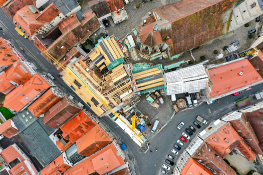 Aerial view of Rathaus Forchheim under renovation with scaffolding and a construction crane among historic red tiled rooftops Forchheim Bayern Germany. Aerial view of Rathaus Forchheim under renovation with scaffolding and a construction crane among historic red tiled rooftops Forchheim Bayern Germany.
