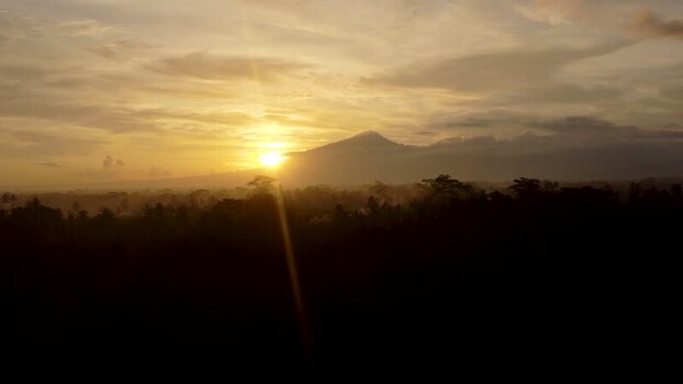 Aerial view of a volcano at sunrise over the tropical forest in Bali Indonesia. Aerial view of a volcano at sunrise over the tropical forest in Bali Indonesia.