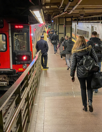 New York United States 14 May 2026 View of passengers walking along the platform next to a red Metro North train at Grand Central Terminal.