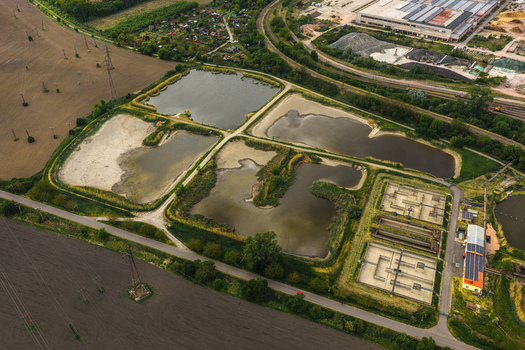 Aerial view of Tepelna elektrarna Hodonin water treatment basins and settling ponds surrounded by green fields and industrial infrastructure in Hodonin Jihomoravsky kraj Czechia. Aerial view of Tepelna elektrarna Hodonin water treatment basins and settling ponds surrounded by green fields and industrial infrastructure in Hodonin Jihomoravsky kraj Czechia.