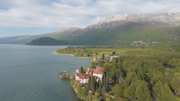 Aerial view of Saint Naum Monastery situated on the shore of Lake Ohrid surrounded by lush greenery and mountains in Municipality of Ohrid North Macedonia.