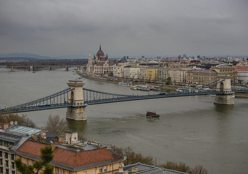 View of the Széchenyi Chain Bridge elegantly spans the flowing Danube with the Hungarian Parliament Building standing majestically Budapest Hungary. View of the Széchenyi Chain Bridge elegantly spans the flowing Danube with the Hungarian Parliament Building standing majestically Budapest Hungary.