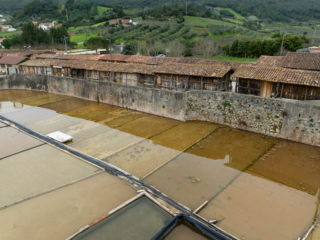 Aerial view of Salinas de Rio Maior salt pans with traditional wooden storage buildings stone walls and evaporation ponds in the rural landscape of Rio Maior Santarem Portugal. Aerial view of Salinas de Rio Maior salt pans with traditional wooden storage buildings stone walls and evaporation ponds in the rural landscape of Rio Maior Santarem Portugal.