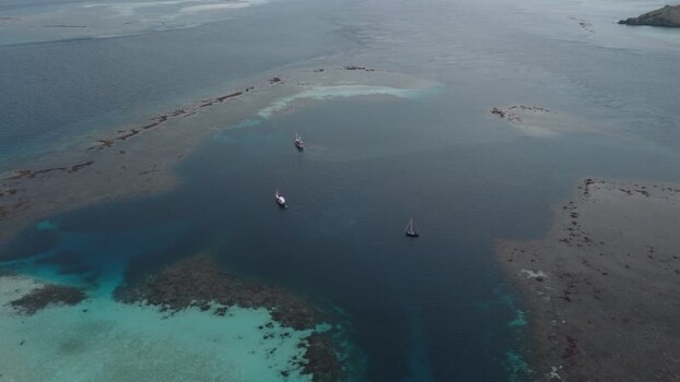 Aerial view of boats in the turquoise waters of Komodo Indonesia.