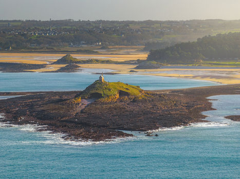 Aerial view of the Saint Michel chapel on a rocky islet surrounded by turquoise water and sandy beaches in Plurien Brittany France. Aerial view of the Saint Michel chapel on a rocky islet surrounded by turquoise water and sandy beaches in Plurien Brittany France.