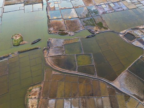 Aerial view of geometric salt pans and traditional wooden boats in the coastal wetlands of Moheskhali Upazila Chittagong Division Bangladesh. Aerial view of geometric salt pans and traditional wooden boats in the coastal wetlands of Moheskhali Upazila Chittagong Division Bangladesh.