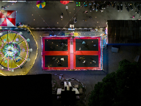 Aerial view of GOR Gelarsena Klaten Night Market with a Ferris wheel and a large trampoline area with people at night in Kecamatan Klaten Utara Jawa Tengah Indonesia. Aerial view of GOR Gelarsena Klaten Night Market with a Ferris wheel and a large trampoline area with people at night in Kecamatan Klaten Utara Jawa Tengah Indonesia.