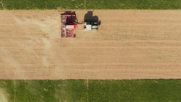 Aerial view of a tractor seeding a field Czechia. Aerial view of a tractor seeding a field Czechia.