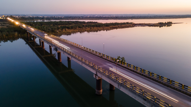 Aerial view of the Jhelum bridge spanning the river with car light trails during sunset Jhelum Punjab Pakistan. Aerial view of the Jhelum bridge spanning the river with car light trails during sunset Jhelum Punjab Pakistan.