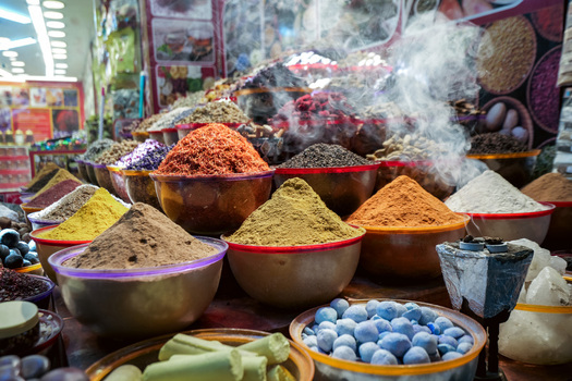 Dubai United Arab Emirates 21 April 2023 View of colorful spice mounds in bowls at the traditional spice souk with aromatic powders and herbs displayed in a market stall. Dubai United Arab Emirates 21 April 2023 View of colorful spice mounds in bowls at the traditional spice souk with aromatic powders and herbs displayed in a market stall.