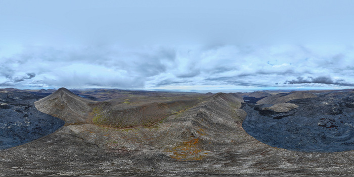 Aerial view of the Geldingadalir Volcano with dark lava fields and volcanic cones under a cloudy sky in Grindavik Grindavikurbaer Iceland.