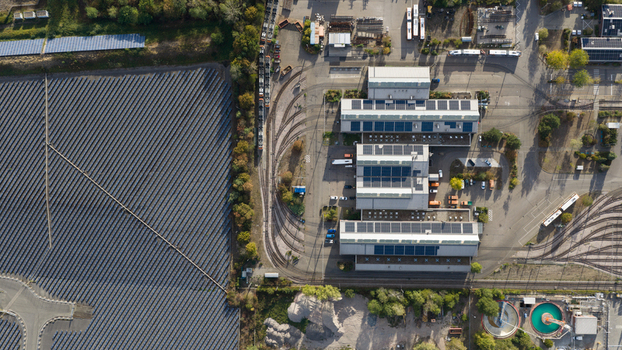 Aerial view of Rhein Neckar Verkehr GmbH depot with industrial buildings solar panels tram tracks and an adjacent solar farm in Ludwigshafen am Rhein Rheinland Pfalz Germany. Aerial view of Rhein Neckar Verkehr GmbH depot with industrial buildings solar panels tram tracks and an adjacent solar farm in Ludwigshafen am Rhein Rheinland Pfalz Germany.