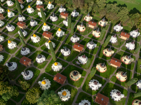 Slagharen Netherlands 03 October 2023 Aerial view of a whimsical village of teepee like structures and cozy cabins nestled in a verdant grid bathed in the warm glow of autumn light. Slagharen Netherlands 03 October 2023 Aerial view of a whimsical village of teepee like structures and cozy cabins nestled in a verdant grid bathed in the warm glow of autumn light.