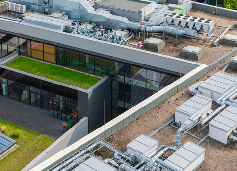 Aerial view of Poznan University of Technology Warta Campus featuring modern architecture with green roof sections and extensive rooftop HVAC systems in Poznan Greater Poland Voivod Poland. Aerial view of Poznan University of Technology Warta Campus featuring modern architecture with green roof sections and extensive rooftop HVAC systems in Poznan Greater Poland Voivod Poland.