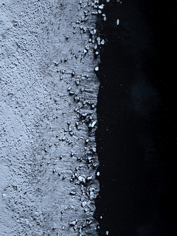 Aerial view of ice chunks scattered on the black sand of Diamond Beach in Sveitarfelagid Hornaf Iceland.
