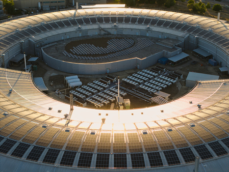 Aerial view of the Diamond Light Source research facility featuring its distinctive circular architecture rooftop solar panels and surrounding industrial infrastructure in Didcot England United Kingdom.