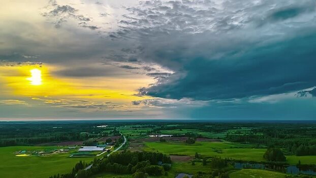 Aerial view of green fields and dramatic sunset sky in Latvia. Aerial view of green fields and dramatic sunset sky in Latvia.