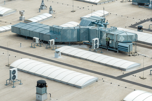 Aerial view of industrial rooftop with advanced HVAC systems ventilation ducts and skylights in Warszawa Mazowieckie Poland. Aerial view of industrial rooftop with advanced HVAC systems ventilation ducts and skylights in Warszawa Mazowieckie Poland.