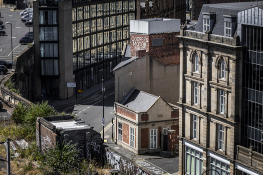 Aerial view of the historic Cooper s Motor Mart building nestled among modern and traditional architecture in Newcastle upon Tyne England United Kingdom. Aerial view of the historic Cooper s Motor Mart building nestled among modern and traditional architecture in Newcastle upon Tyne England United Kingdom.