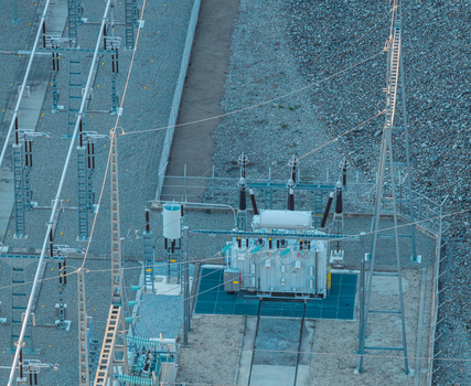 Aerial view of a high voltage power transformer and electrical switchgear at a substation in Rousset Serre Poncon Provence Alpes Cote d Azur France.