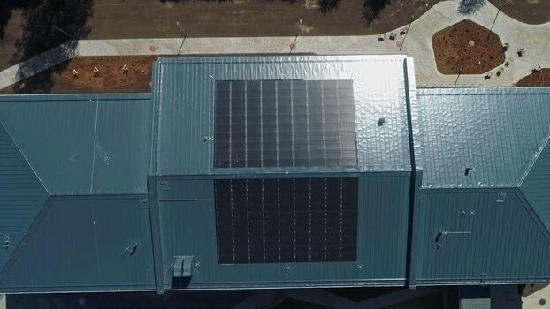 Aerial view of solar panels on a metal roof in Latvia.