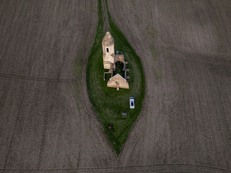 Aerial view of the historic Pusztatorony church ruins standing in a grassy field surrounded by vast plowed agricultural lands in Somogyvamos Hungary. Aerial view of the historic Pusztatorony church ruins standing in a grassy field surrounded by vast plowed agricultural lands in Somogyvamos Hungary.