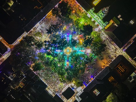 Aerial view of a vibrant square illuminated with colorful lights nestled among dark buildings and lush trees Salamina Caldas Colombia. Aerial view of a vibrant square illuminated with colorful lights nestled among dark buildings and lush trees Salamina Caldas Colombia.