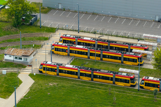 Aerial view of modern yellow and red trams parked at a tram depot in Warszawa Mazowieckie Voivodeship Poland. Aerial view of modern yellow and red trams parked at a tram depot in Warszawa Mazowieckie Voivodeship Poland.