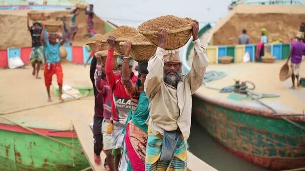 View of workers carrying sand baskets at Aminbazar Bangladesh.