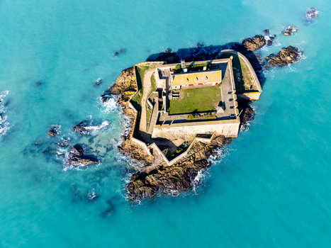 Aerial view of Fort National standing defiant against the turquoise sea its ancient stone walls a stark contrast to the vibrant water Saint Malo Brittany France. Aerial view of Fort National standing defiant against the turquoise sea its ancient stone walls a stark contrast to the vibrant water Saint Malo Brittany France.