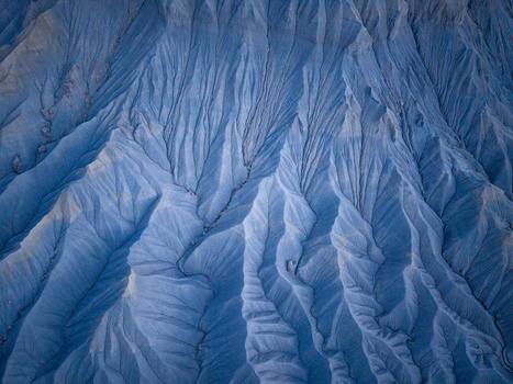 Aerial view of the intricate eroded ridges and deep gullies of the badlands showcasing textured clay formations and natural patterns in Caineville Utah United States. Aerial view of the intricate eroded ridges and deep gullies of the badlands showcasing textured clay formations and natural patterns in Caineville Utah United States.