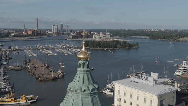 Aerial view of Uspenski Cathedral with its golden dome overlooking the harbor boats and the cityscape of Helsinki Uusimaa Finland. Aerial view of Uspenski Cathedral with its golden dome overlooking the harbor boats and the cityscape of Helsinki Uusimaa Finland.