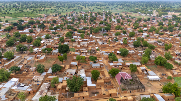 Aerial view of Dambatta featuring traditional mud brick houses narrow streets scattered trees and a communication tower in Dambatta Kano Nigeria. Aerial view of Dambatta featuring traditional mud brick houses narrow streets scattered trees and a communication tower in Dambatta Kano Nigeria.