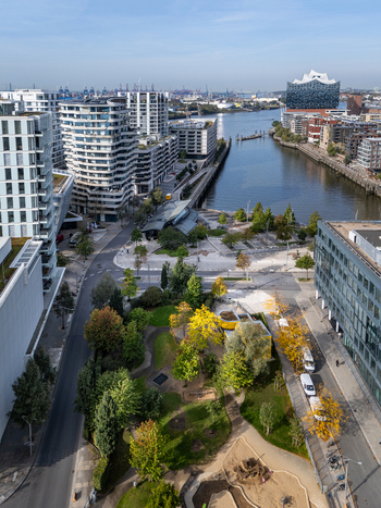 Aerial view of Marco Polo Terraces surrounded by modern residential buildings green park spaces and the Elbphilharmonie in the background in Hamburg Germany.