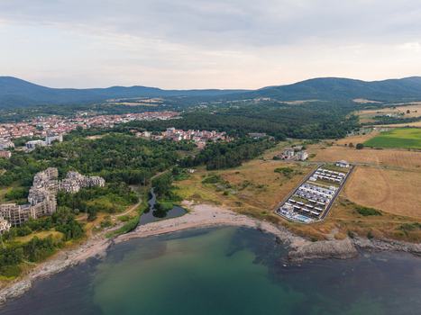 Aerial view of the coastal landscape at Arapya Camping featuring a sandy beach a river mouth modern holiday villas and surrounding forest near Tsarevo Burgas Bulgaria. Aerial view of the coastal landscape at Arapya Camping featuring a sandy beach a river mouth modern holiday villas and surrounding forest near Tsarevo Burgas Bulgaria.