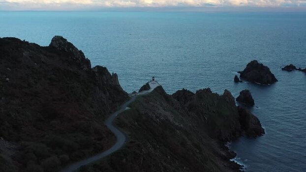 Aerial view of Faro do Cabo Ortegal on rocky cliffs Spain.