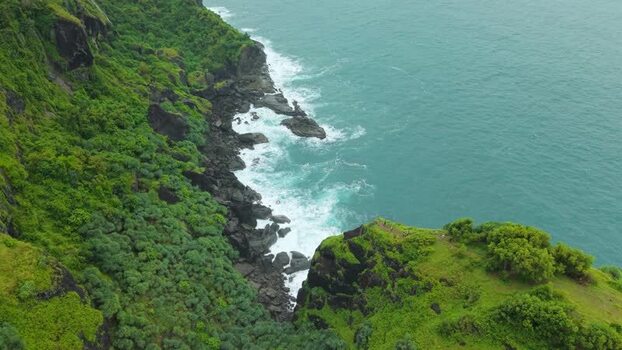 Aerial view of Bukit Pengilon cliffs and ocean waves Indonesia.