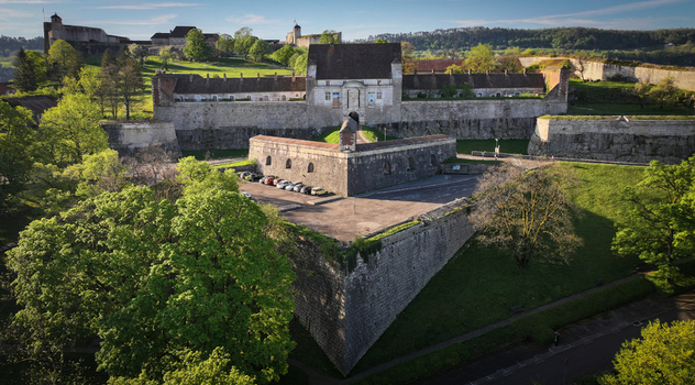 Aerial view of Besancon Citadel with its massive stone fortifications green ramparts and surrounding trees in Besancon Bourgogne Franche Com France. Aerial view of Besancon Citadel with its massive stone fortifications green ramparts and surrounding trees in Besancon Bourgogne Franche Com France.