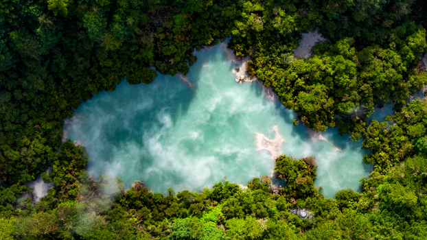 Aerial view of the vibrant turquoise pool surrounded by dense verdant forest Waiotapu Waikato Region New Zealand. Aerial view of the vibrant turquoise pool surrounded by dense verdant forest Waiotapu Waikato Region New Zealand.
