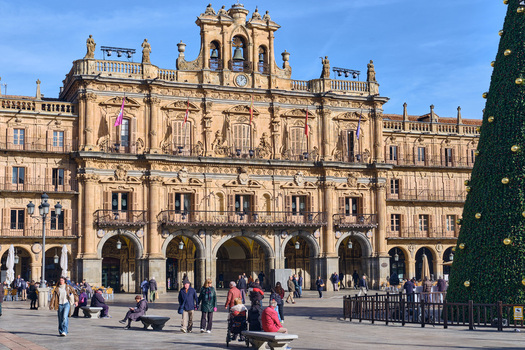 Salamanca Spain 01 December 2025 View of the baroque Town Hall in Plaza Mayor with a large Christmas tree and people walking across the square under a clear blue sky. Salamanca Spain 01 December 2025 View of the baroque Town Hall in Plaza Mayor with a large Christmas tree and people walking across the square under a clear blue sky.