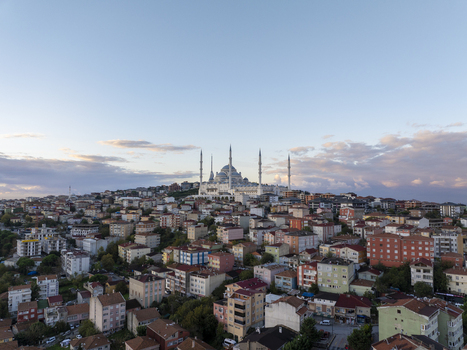 Aerial view of the Grand Camlica Mosque rising above the dense urban landscape of residential buildings and rooftops in Uskudar Istanbul Turkiye. Aerial view of the Grand Camlica Mosque rising above the dense urban landscape of residential buildings and rooftops in Uskudar Istanbul Turkiye.