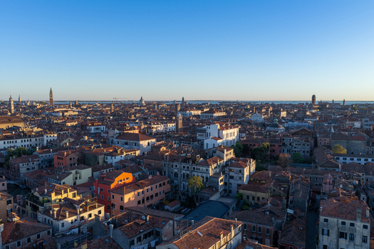 Aerial view of the historic city of Venice with its dense network of terracotta rooftops church domes and winding canals in Venice Veneto Italy. Aerial view of the historic city of Venice with its dense network of terracotta rooftops church domes and winding canals in Venice Veneto Italy.