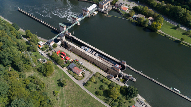 Aerial view of the Neckar Staustufe und Schleuse Rockenau a lock and weir system on the Neckar River with concrete walls and surrounding greenery in Eberbach Baden Wurttemberg Germany. Aerial view of the Neckar Staustufe und Schleuse Rockenau a lock and weir system on the Neckar River with concrete walls and surrounding greenery in Eberbach Baden Wurttemberg Germany.