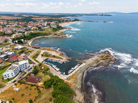 Aerial view of the coastal town of Lozenets with its small harbor filled with boats sandy beaches and surrounding green landscape in Lozenets Burgas Bulgaria.