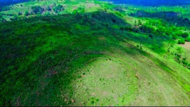 Aerial view of lush green rolling hills and grassy slopes in the Ashanti Region Ghana.