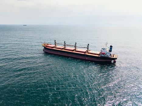 Aerial view of a large bulk carrier cargo ship with red and black hull anchored in the calm blue waters of the Black Sea near Varna Varna Bulgaria. Aerial view of a large bulk carrier cargo ship with red and black hull anchored in the calm blue waters of the Black Sea near Varna Varna Bulgaria.